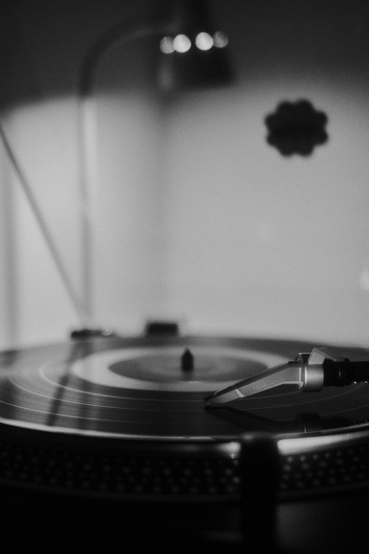Through the grooves he can hear suave music.
